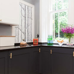 This kitchen features coordinating gold toned accessories, creating a glamorous look