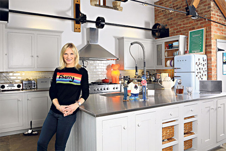 Radio 2 DJ Jo Whiley in her kitchen, which has stainless steel worktops and a neutral colour scheme