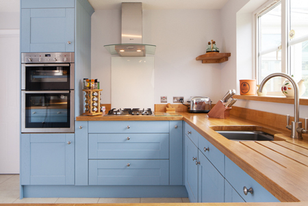 These solid oak kitchen cabinets have been painted Lulworth Blue by Farrow & Ball.