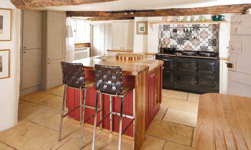 This kitchen island features a rich red colour which complements the rest of the kitchen.