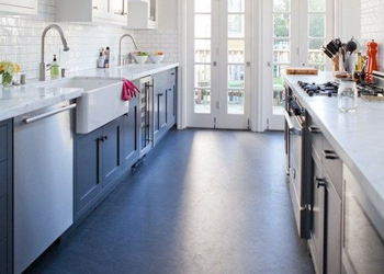 Dark coloured Linoleum has been used in this kitchen to complement the cabinets.