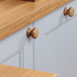 Traditional-style cabinets painted in a light blue and topped with a solid oak worktop.