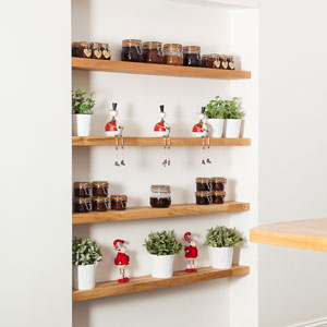 Four floating shelves with condiment jars, decorative elements and potted plants