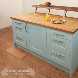 An oak kitchen island with solid oak kitchen cabinets painted in blue ground.
