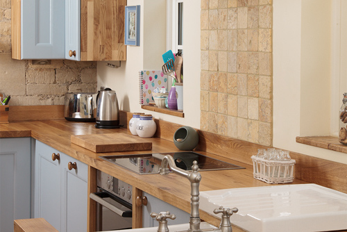 The exposed stonework in this kitchen combines beautifully with Traditional frontals in Farrow & Ball’s Lulworth Blue.