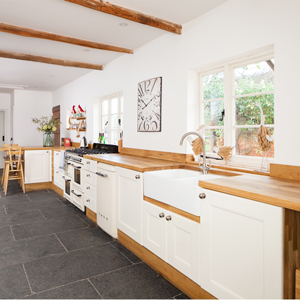 Full stave oak worktops with Wimborne White painted solid oak kitchen cabinets.