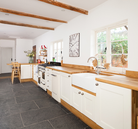 Solid full stave oak worktop and oak kitchen cabinets painted in Farrow & Ball's Wimborne White.