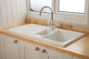This inset ceramic sink is beautifully complemented by the delicate and pale grain of our solid ash worktops.