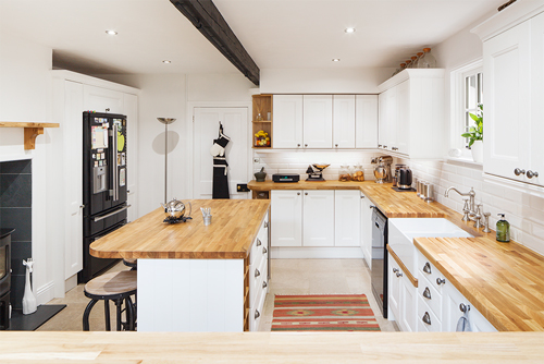 A modern solid oak farmhouse kitchen in All White with gloss white subway tiles