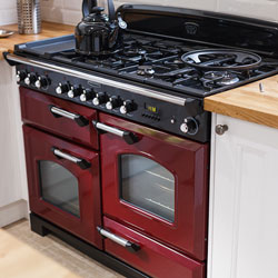 A red range oven in a neutral kitchen