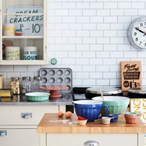 Retro cookware and white subway tiles are well-suited to this vintage-style kitchen solid wood kitchens.