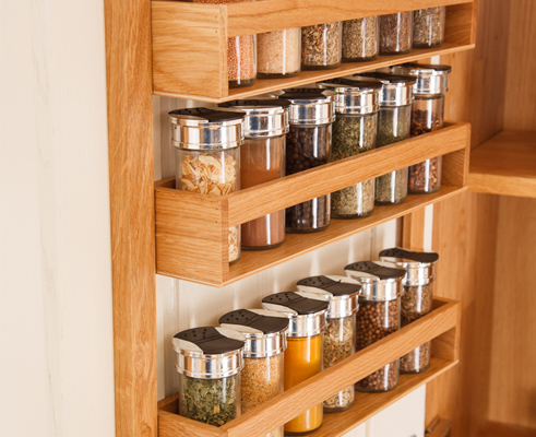 A solid oak spice rack is a fantastic addition to any kitchen unit, working especially well in a full height kitchen larder.