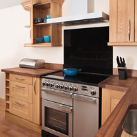 A stainless steel oven alongside our solid wood cabinets and worktops