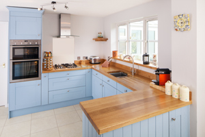Solid oak kitchen with full stave oak worktops and U-shaped layout.