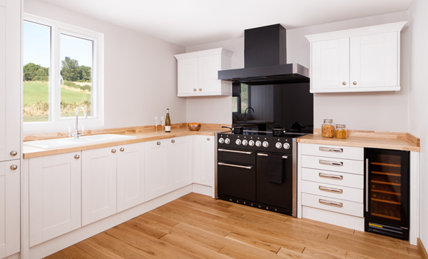 All White Shaker cabinet frontals with worktops in a monochrome look that is softened by the introduction of colour through pastel grey walls.