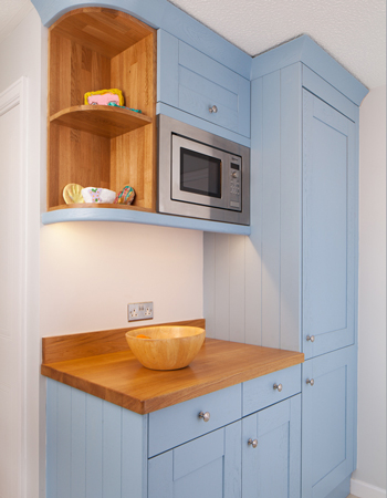 This curved wall cabinet is the perfect candidate for displaying cookbooks.