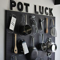 Utilise wall space by hanging pots and utensils off pegboards.