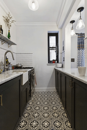 This stylish galley kitchen features a patterned tiled floor and dark base cabinets.