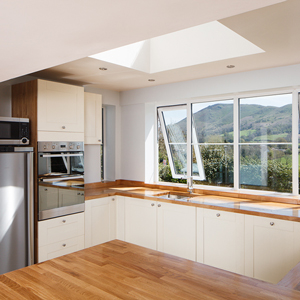 An airy neutral kitchen with large windows and a skylight