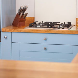 Bright blue cabinetry gives this kitchen a pop of colour