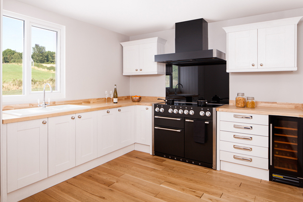 This monochrome kitchen features shaker frontals, a neutral colour palette and minimalistic handles and pulls.