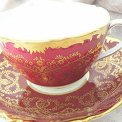 A red and gold China tea cup and saucer