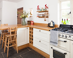 Solid wood kitchen with an oak breakfast bar worktop and SMEG cooker.