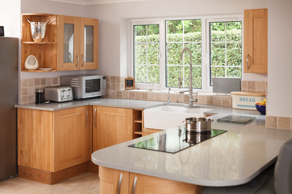 Wall cabinets will have been planned to work around the large window that lets light flood into this beautiful kitchen