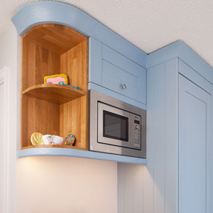 Microwave housing cabinets are a useful space-saving solution for solid wood kitchens